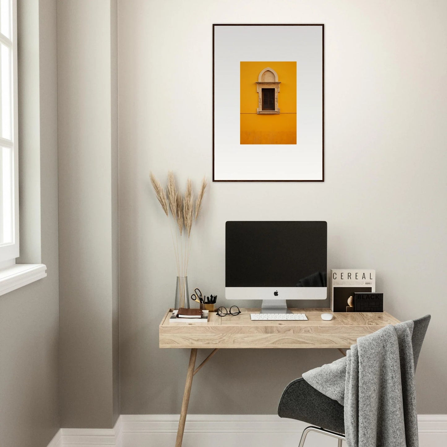 Minimalist wooden desk with iMac and framed wall art for Golden Correspondence Portal