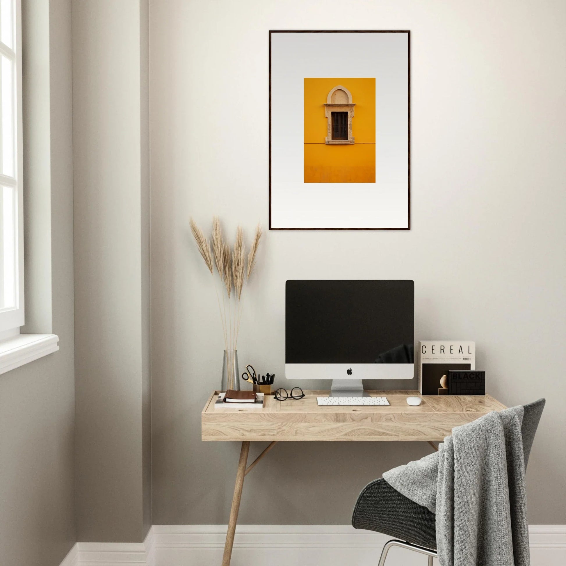 Minimalist wooden desk with iMac and framed wall art for Golden Correspondence Portal