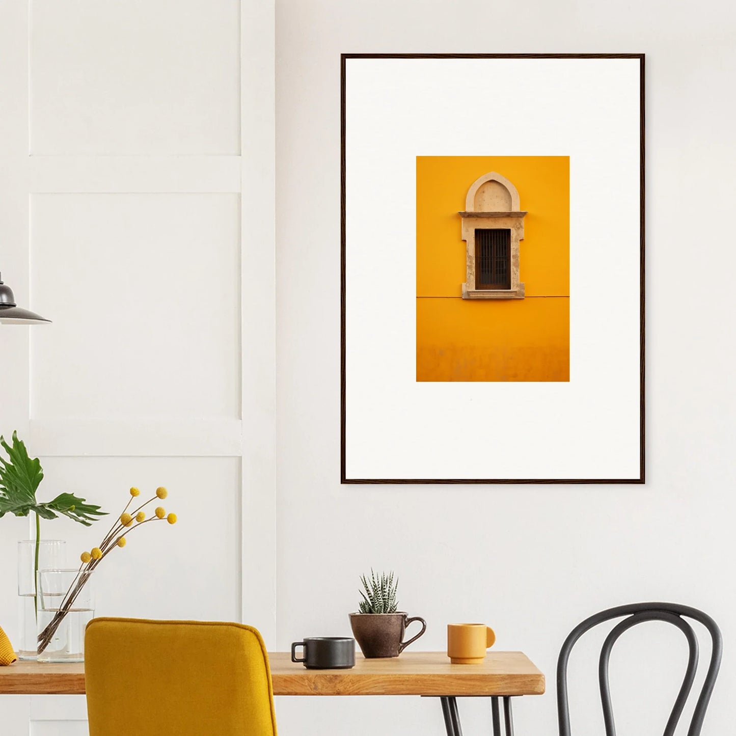 Framed wall art of an arched window on a yellow wall in Golden Correspondence Portal