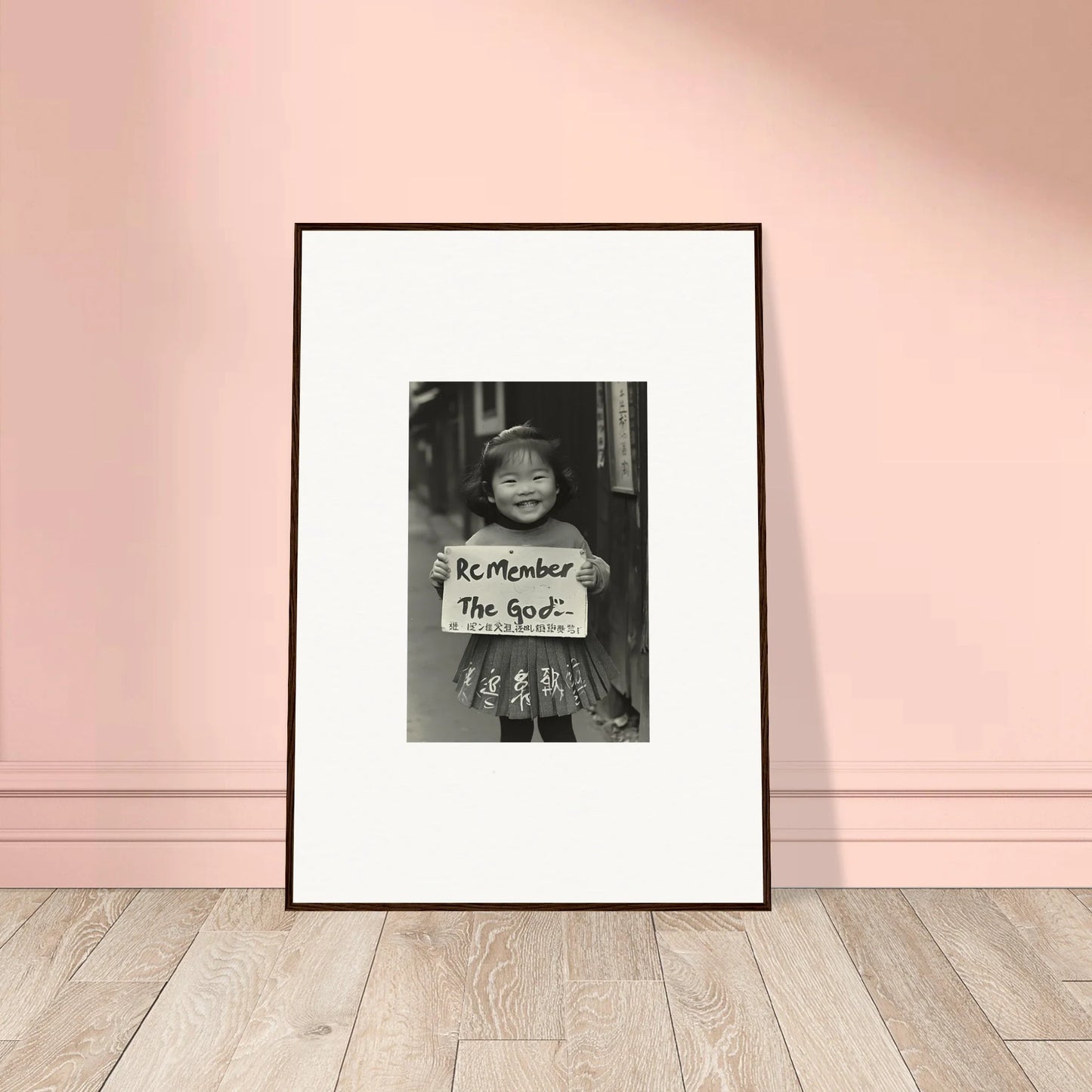 Framed black and white art of someone holding a Remember The Poor sign in Sacred Smile Echoes