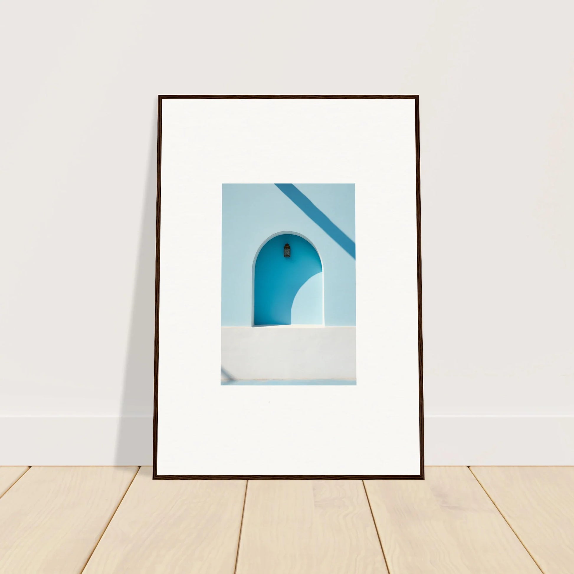 Framed wall art of a white-walled archway brings elusive solitude clarity against blue sky