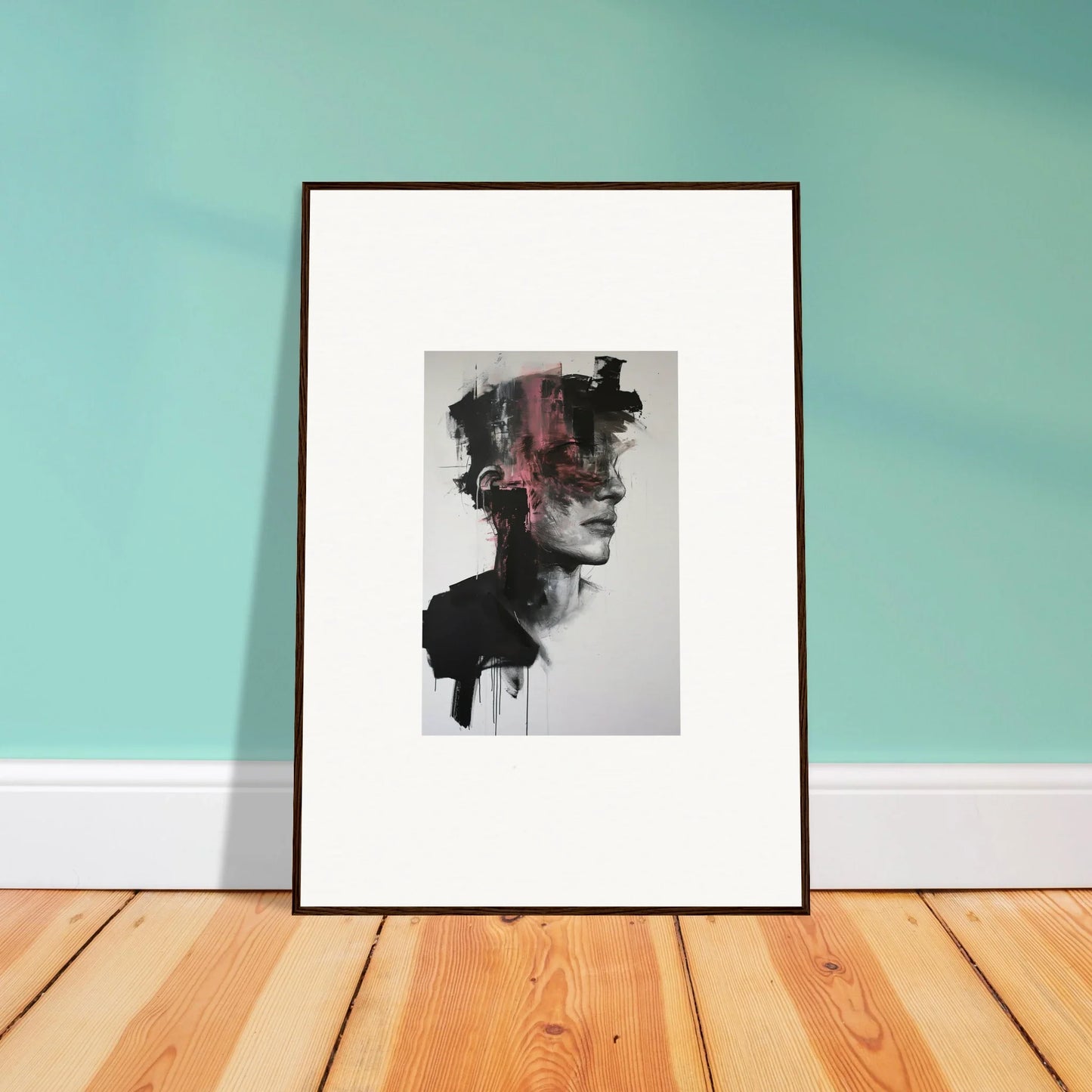 Framed black and white Fragmented Psyche Canvas with pink accents leaning on wall