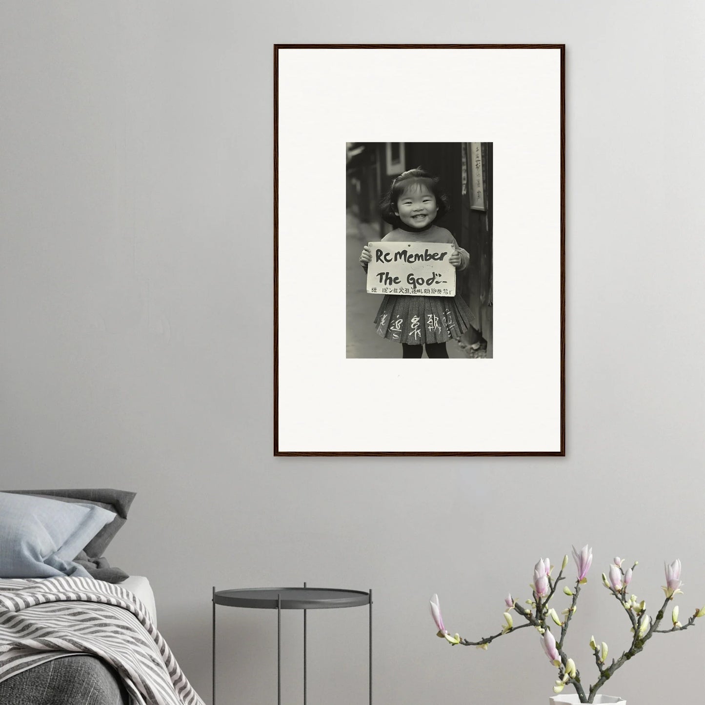 Framed black and white art featuring a child with a sign from Sacred Smile Echoes