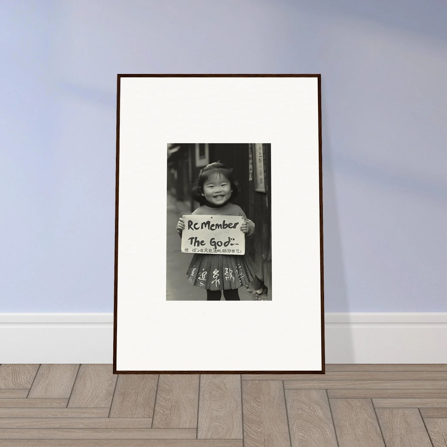 Framed black and white photo of a person with a sign from Sacred Smile Echoes