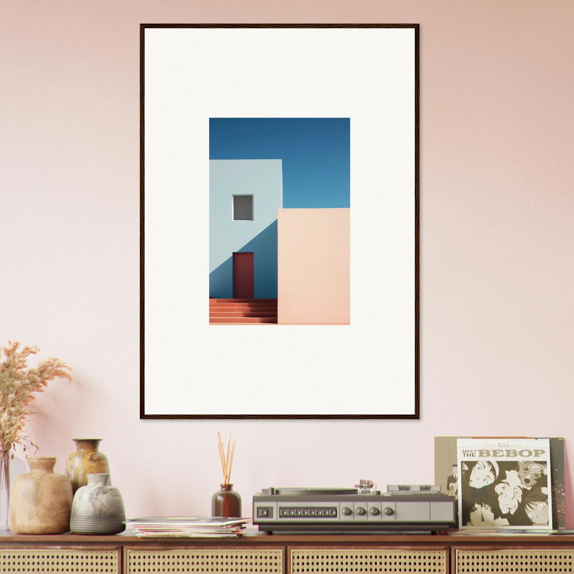 Framed minimalist architectural art featuring white walls, red door, and blue sky