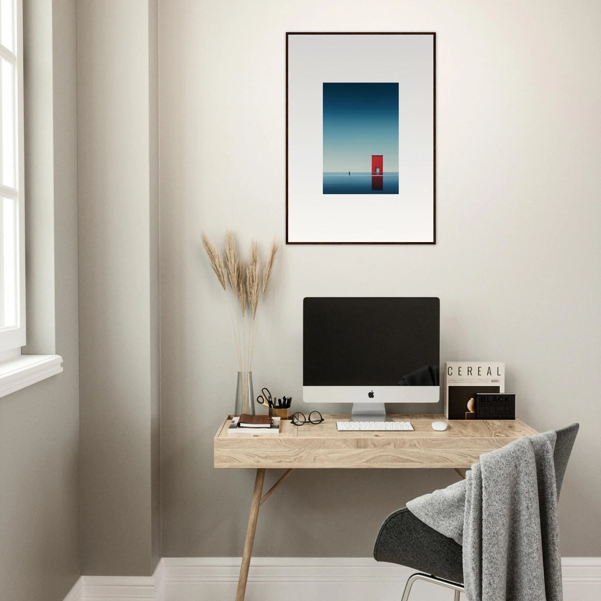 Minimalist workspace featuring an iMac on a wooden desk with Open Horizon artwork