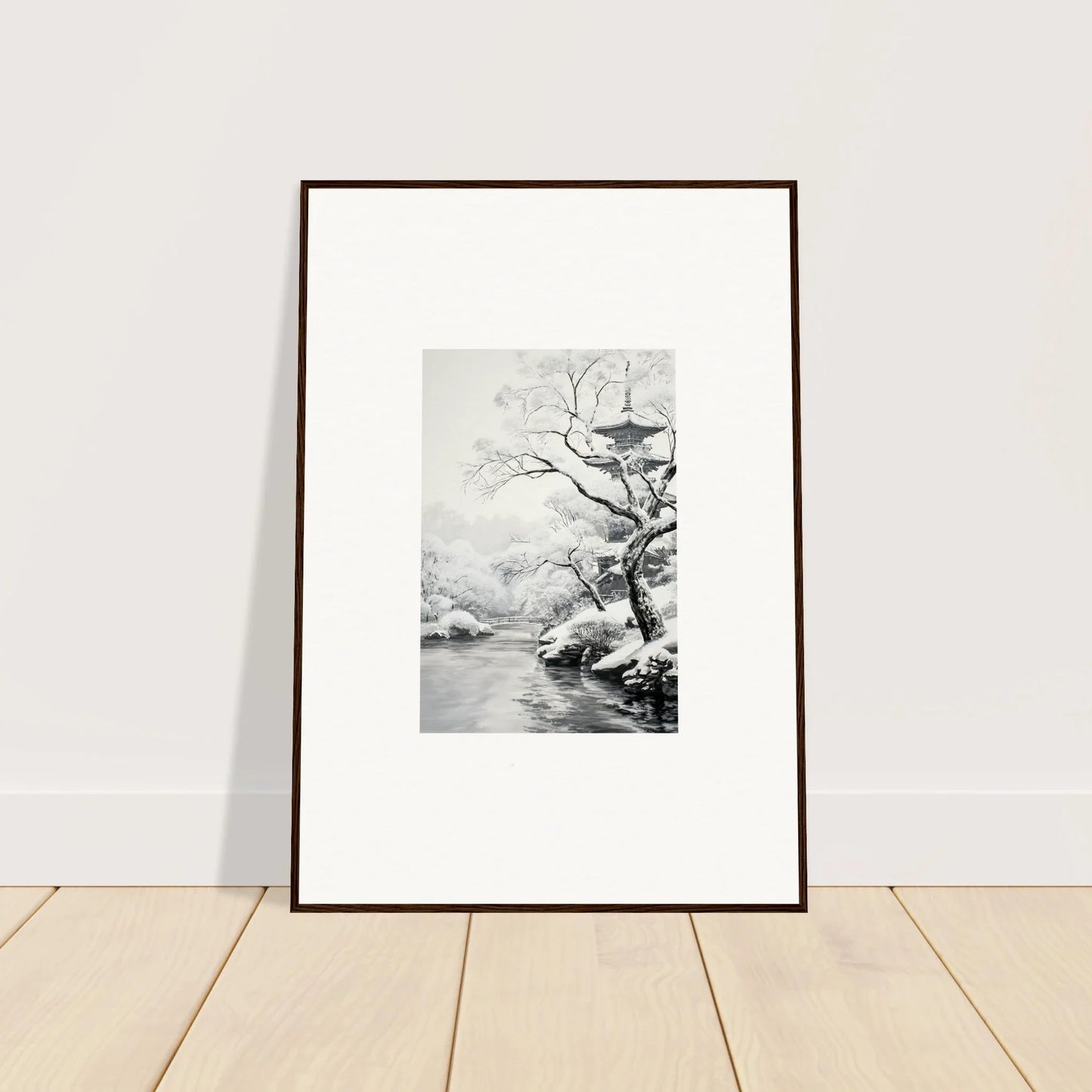 Framed black and white artwork of a tree by water in a Metaphysical Winter Reverie