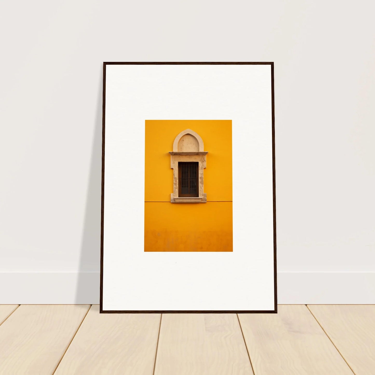 Framed wall art of an ornate window on a yellow wall in the Golden Correspondence Portal