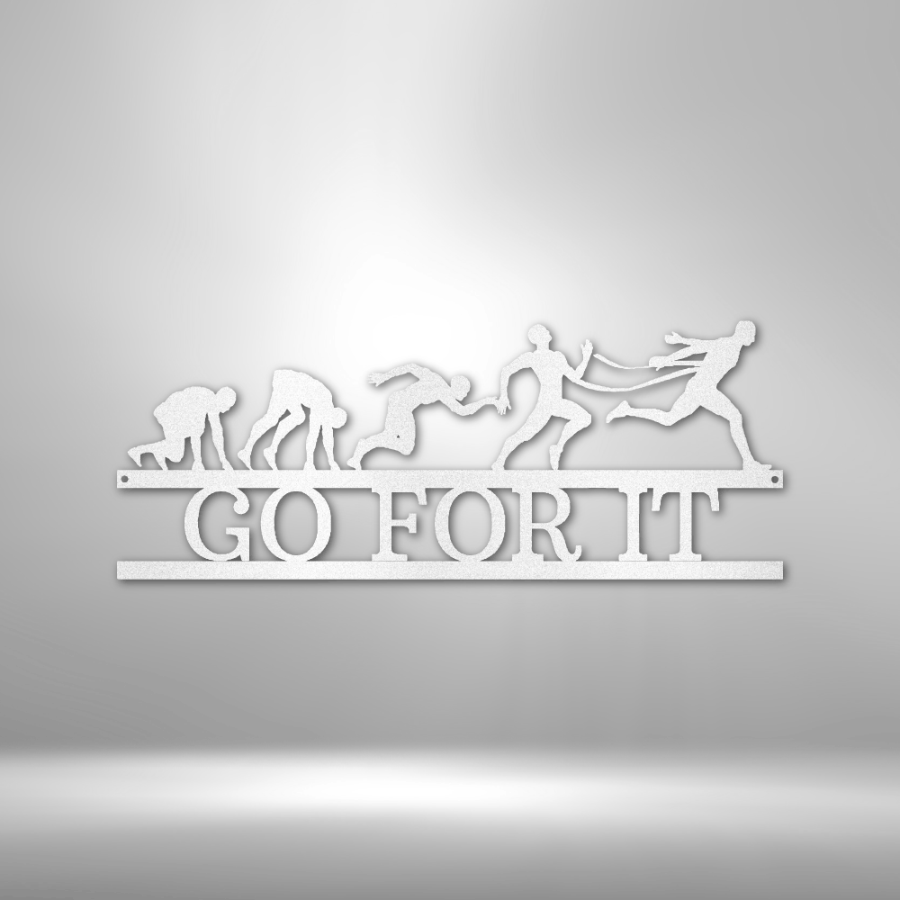 Stylized metal wall art depicting the evolution of running with the text ’GO FOR IT’ underneath.