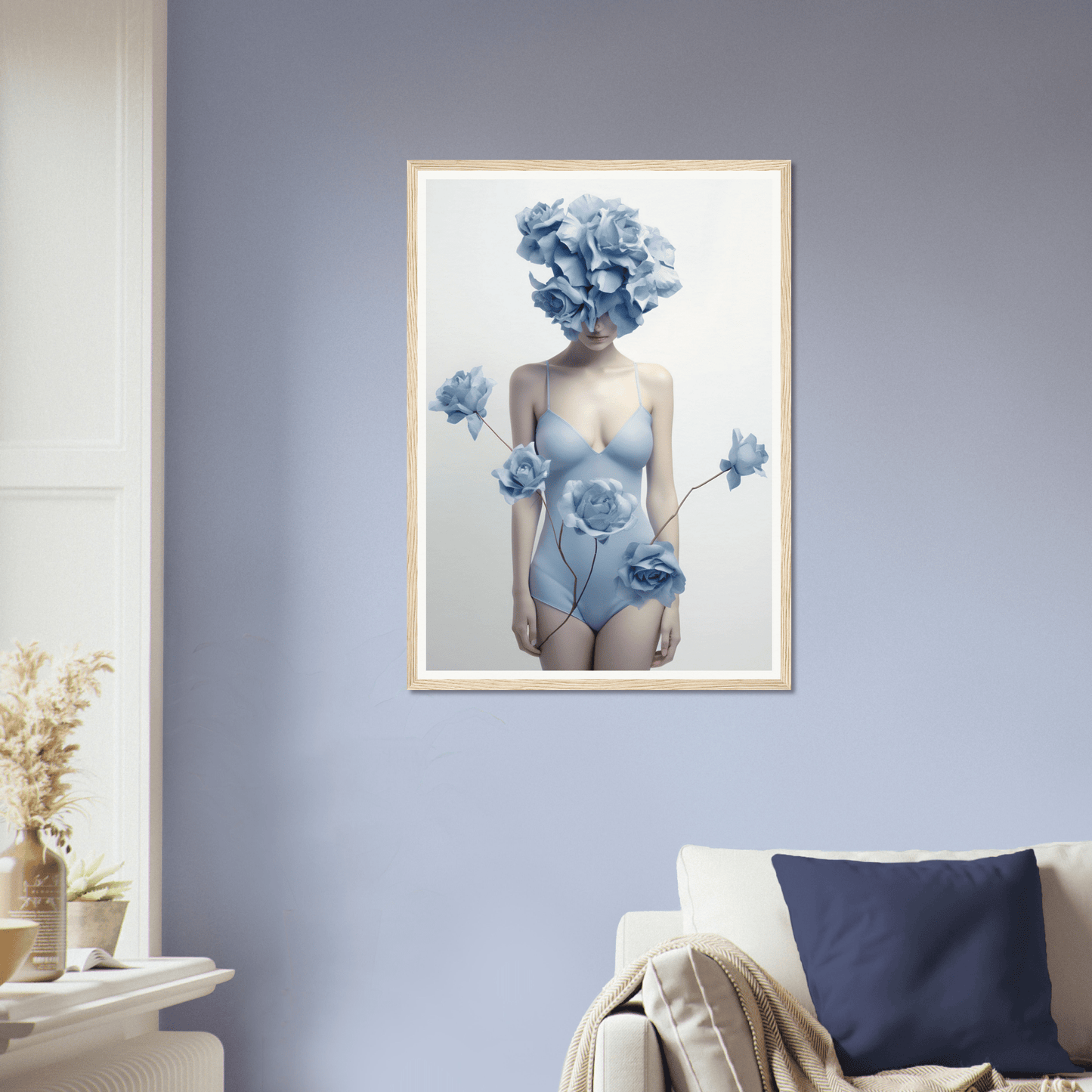 Framed artwork depicting a surreal figure with blue floral elements replacing the head and adorning a pale bodysuit.