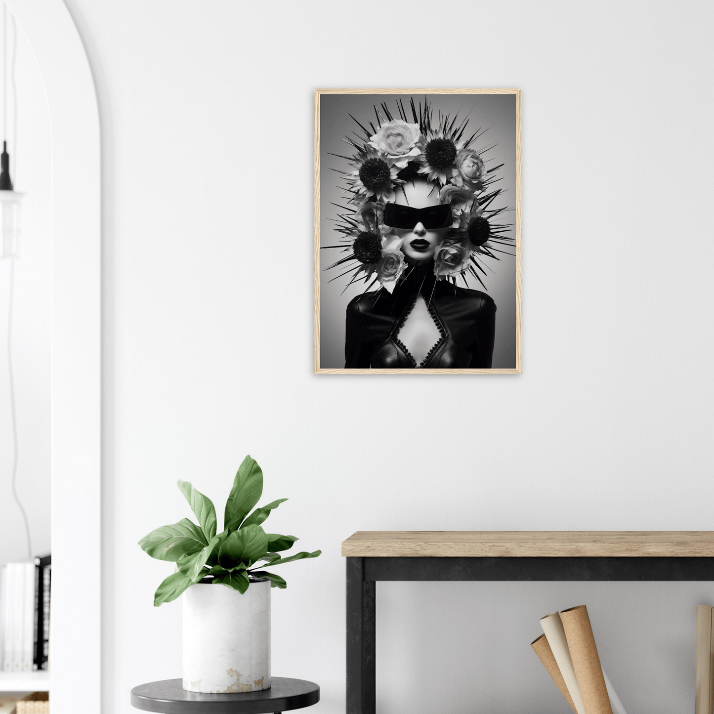 Striking black and white portrait of a figure wearing sunglasses and an elaborate spiked headdress.