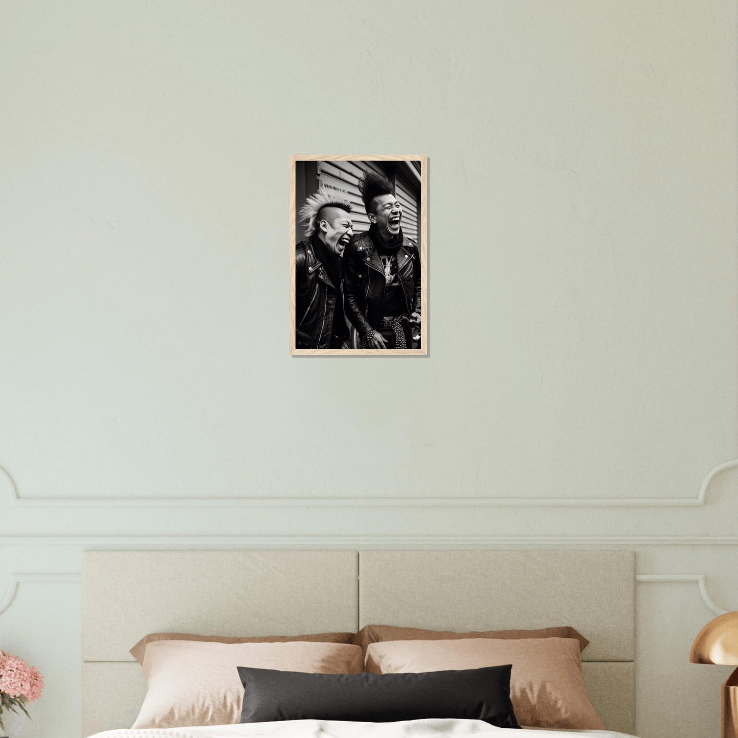 Black and white photograph of two elderly men hanging on a wall above a bed.