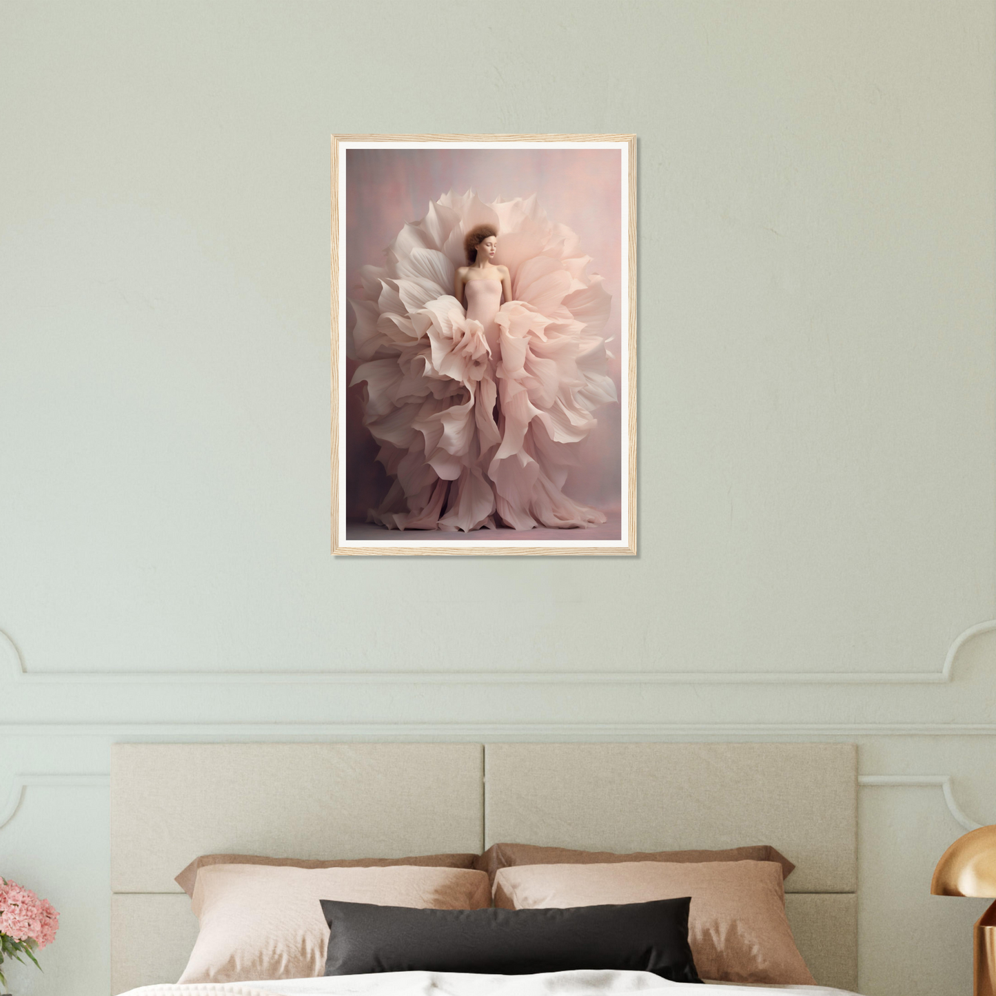 Framed artwork depicting a figure surrounded by billowing, petal-like fabric in soft pink tones.