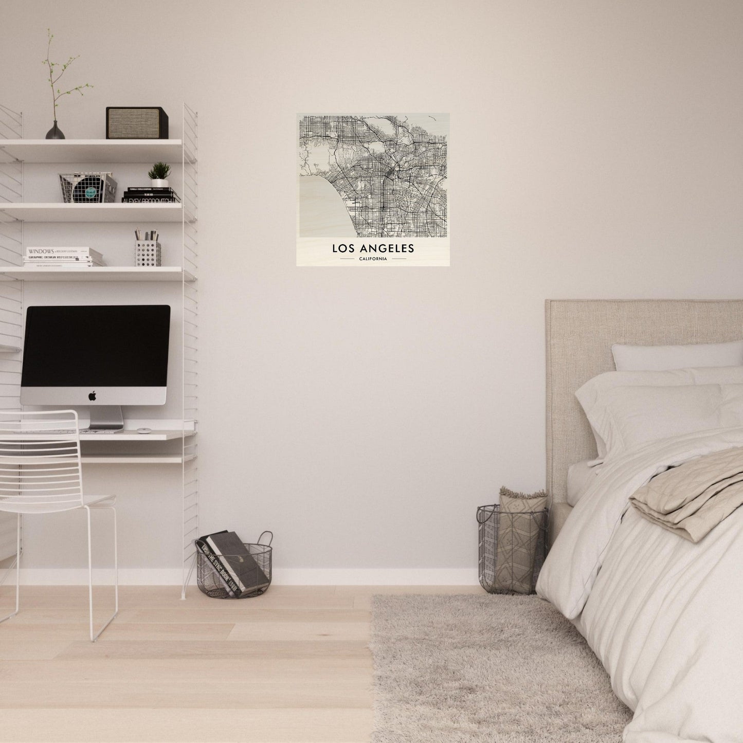 Minimalist bedroom with a workspace featuring white shelves and a map of Los Angeles on the wall.