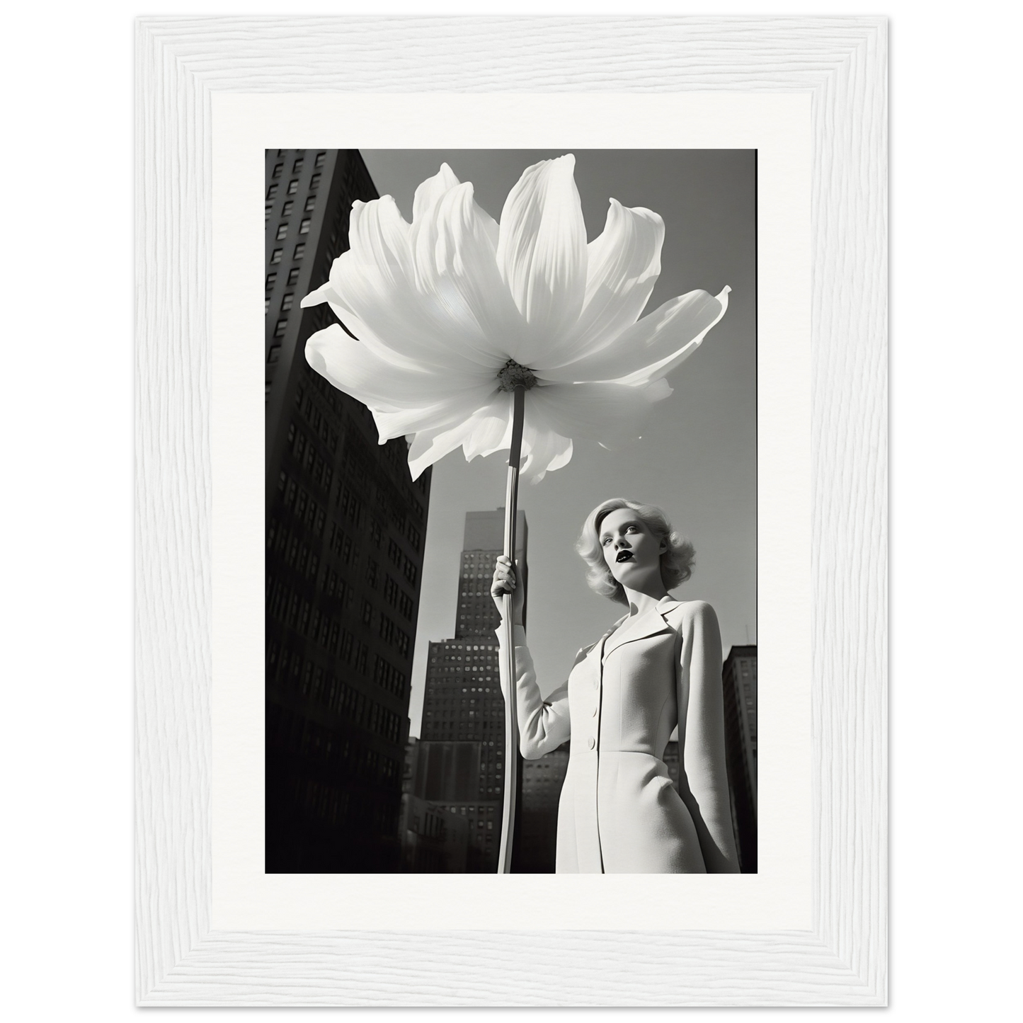 A woman holding a large white flower in front of a tall building