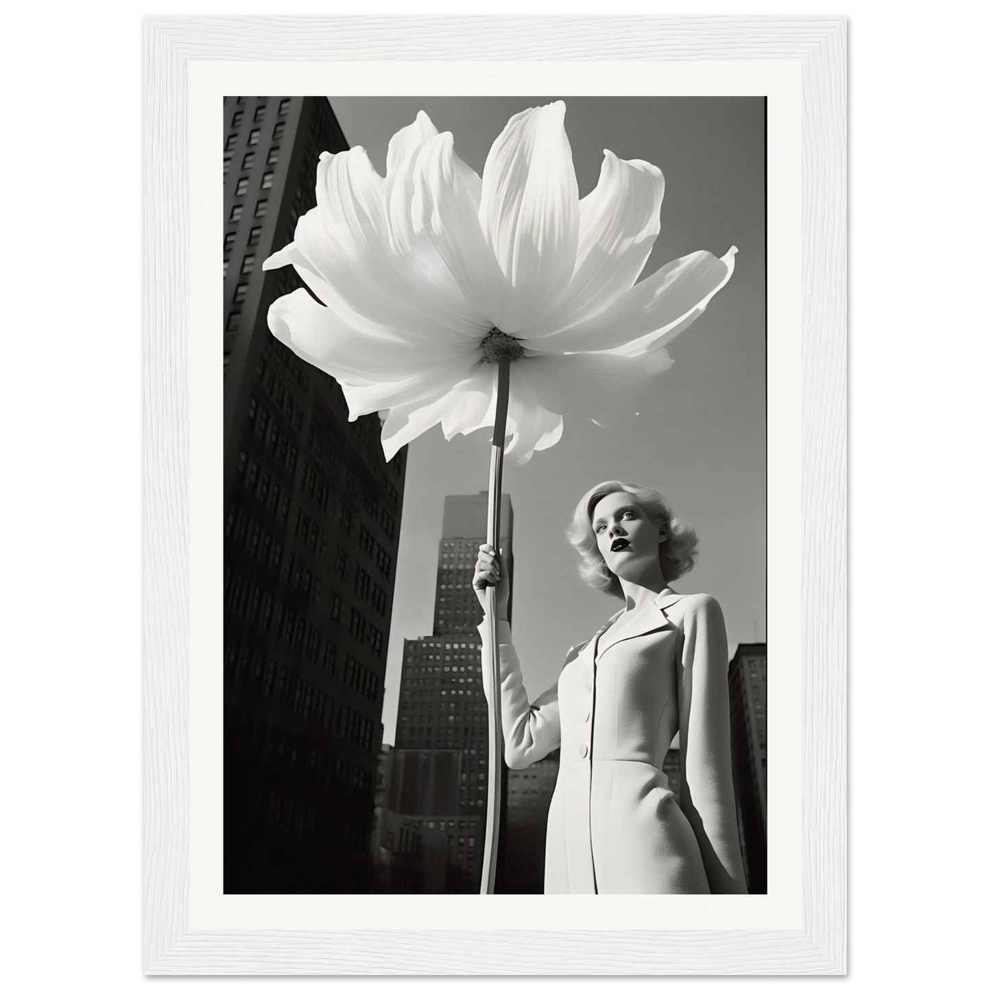 A woman holding a large white flower in front of a tall building