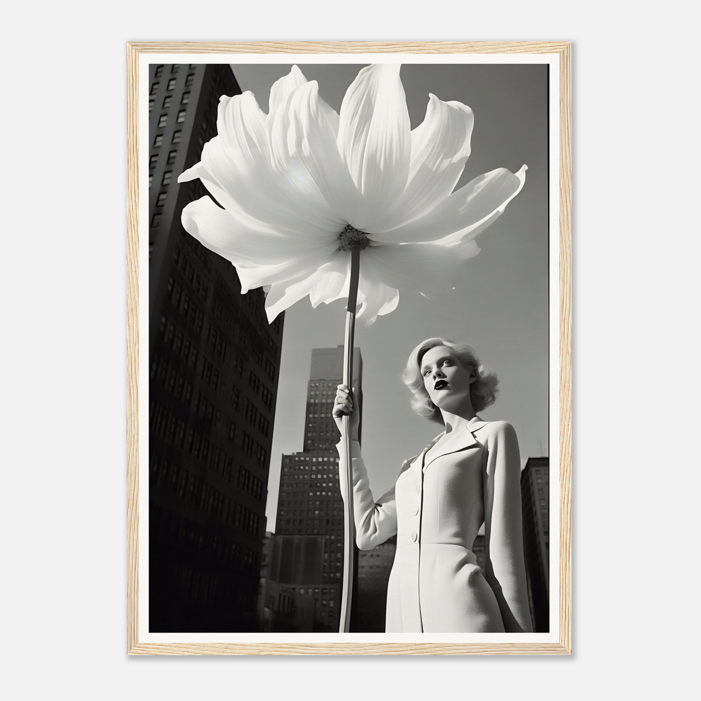 A woman holding a large white flower in front of a tall building