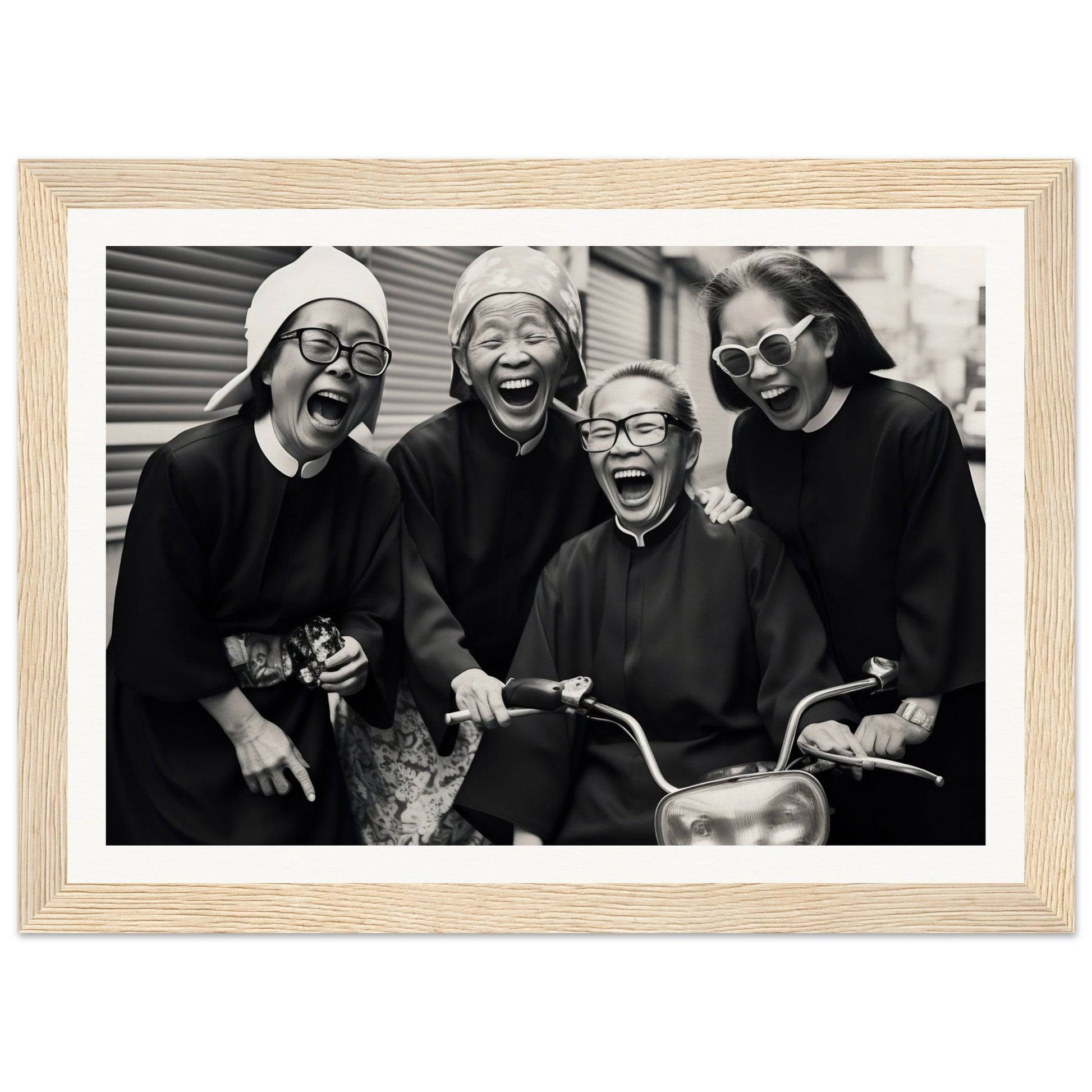 Black and white photograph of four joyful women laughing together.