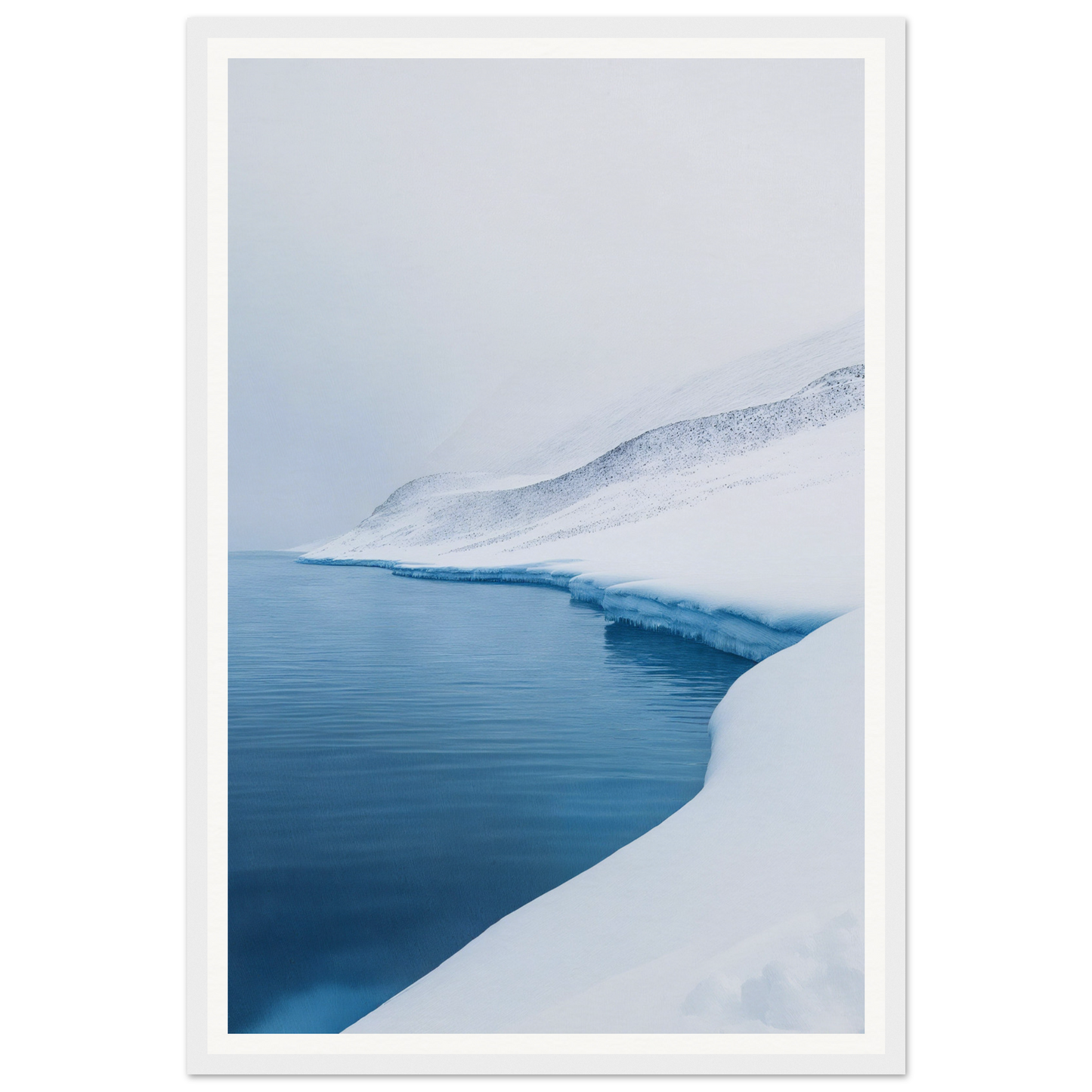 Framed wall art of a snowy landscape with calm blue water and a snowy slope under an overcast sky.