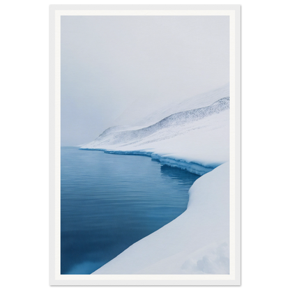 Framed wall art of a snowy landscape with calm blue water and a snowy slope under an overcast sky.