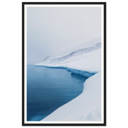 Snow-covered shoreline, calm blue water, perfect for framed wall art under an overcast sky.