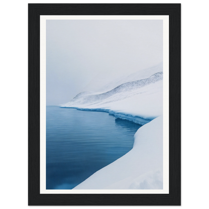 Framed wall art of a snowy landscape with a tranquil, frozen lake.