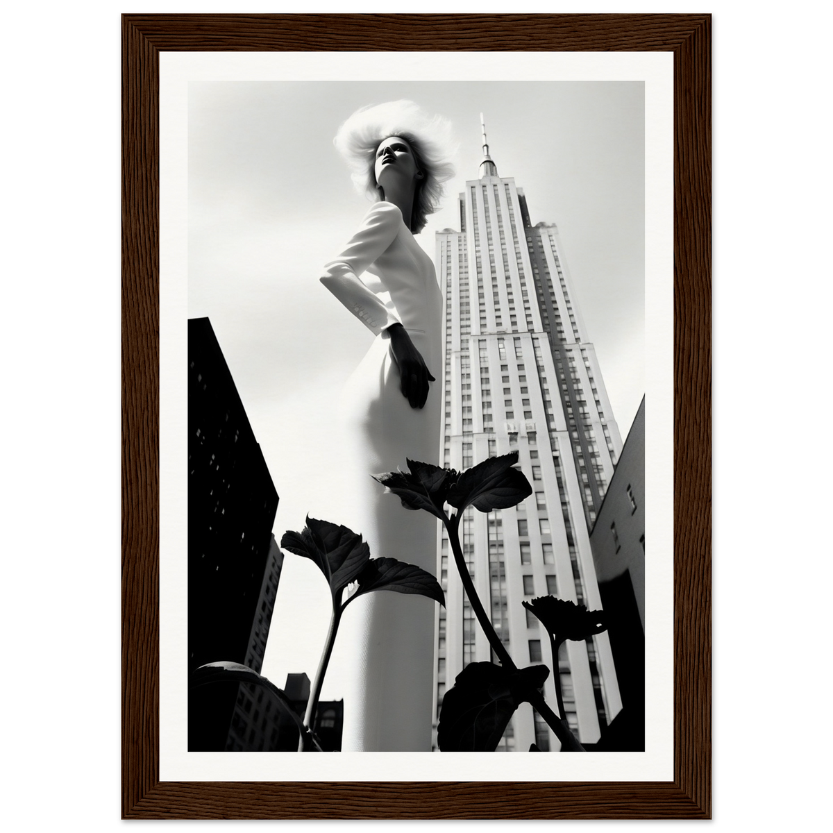 Statuesque woman in a white dress posing dramatically next to the Empire State Building.