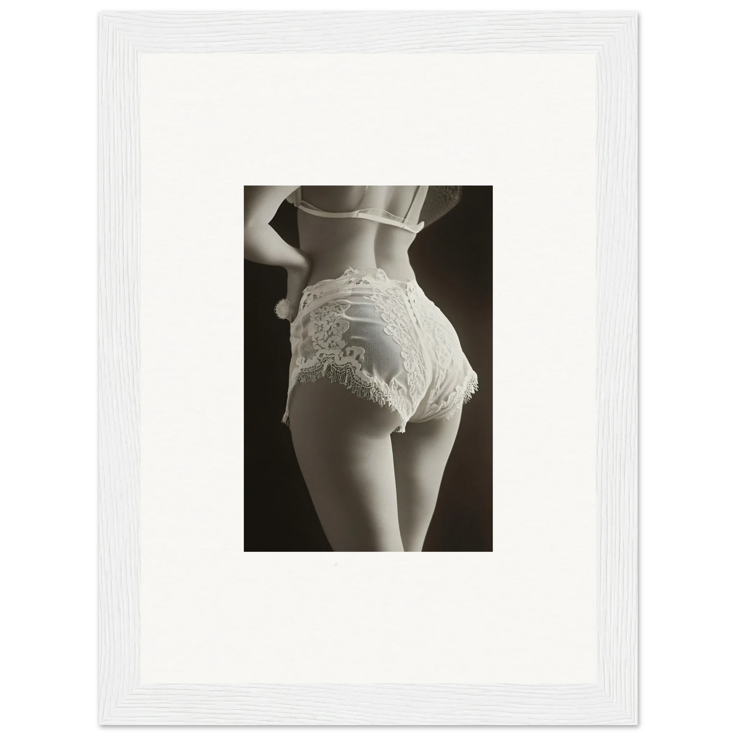 Framed black and white wall art of a woman’s hips in lace for chic room decoration