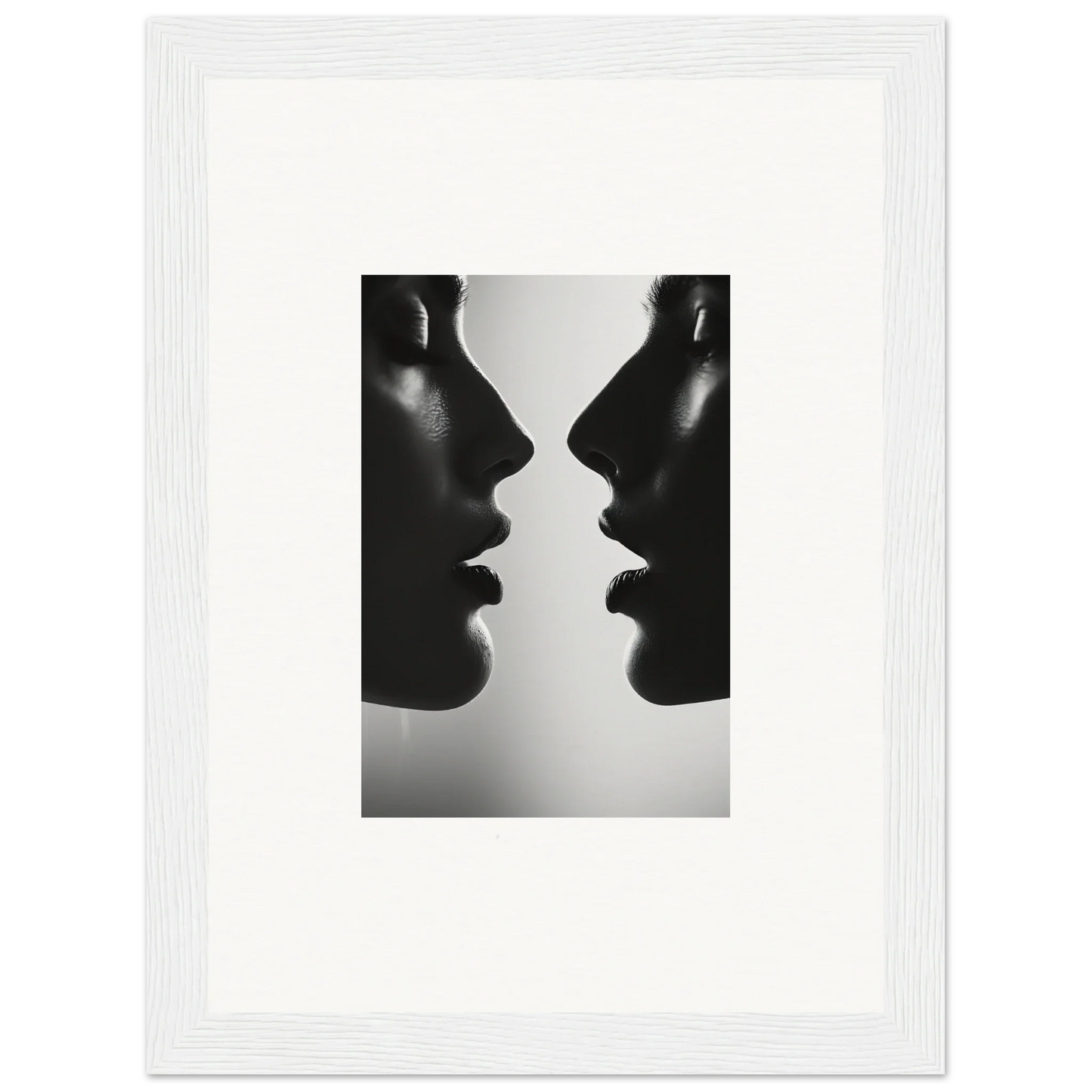 Two silhouetted profiles in black and white from Echo’s Embrace premium framed wall art