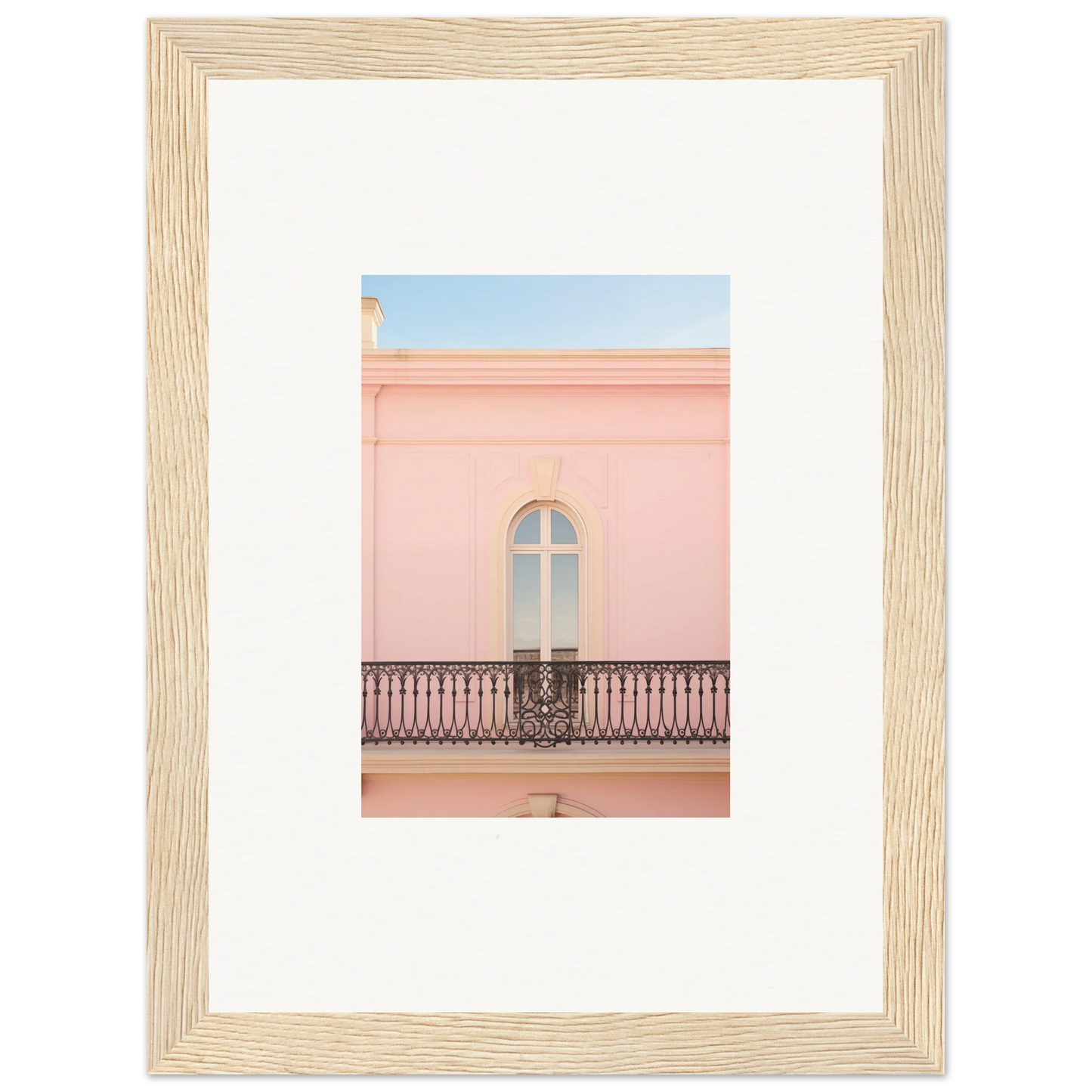 Framed wall art featuring an arched window and balcony of a pink building in Peach Tranquil Portal