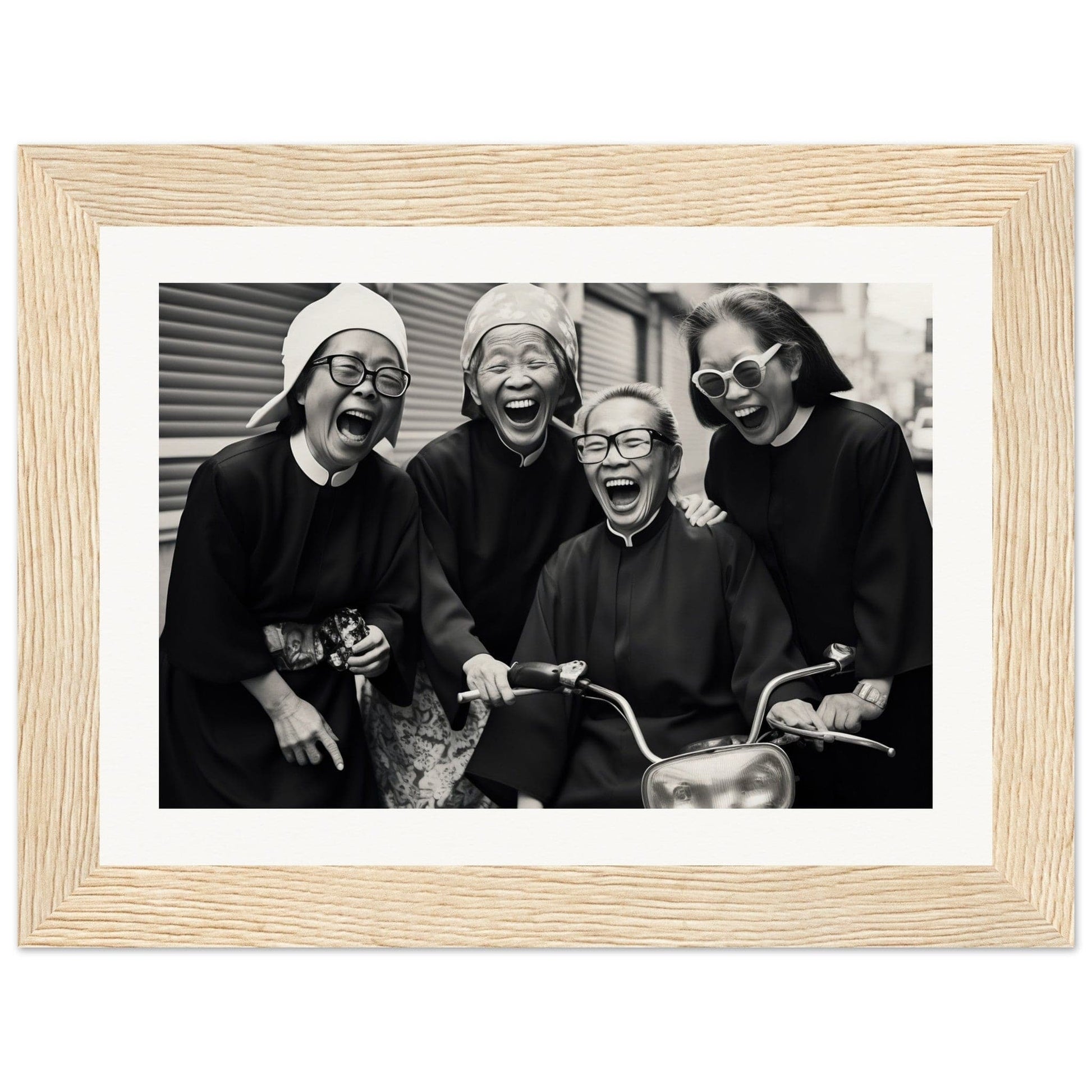 Framed black and white photograph of four joyful people laughing together.