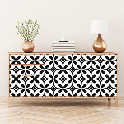 Wooden sideboard with black and white geometric patterned doors.