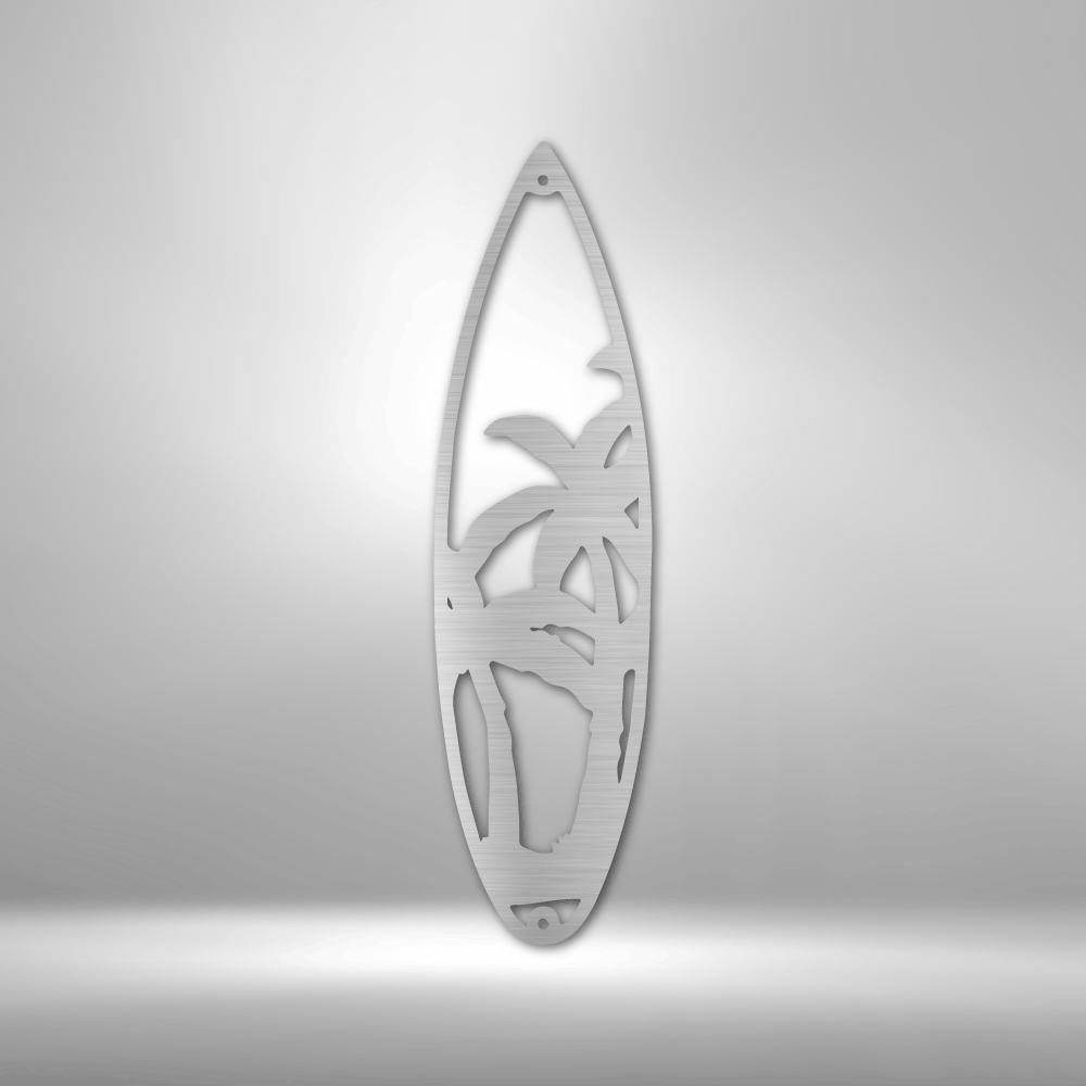 Surfboard-shaped metal sculpture with a palm tree cutout design.