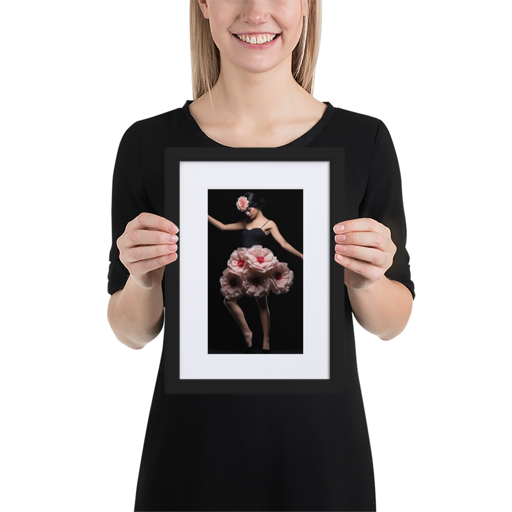 Framed photograph of a ballet dancer in a floral tutu held by a person wearing a black top.