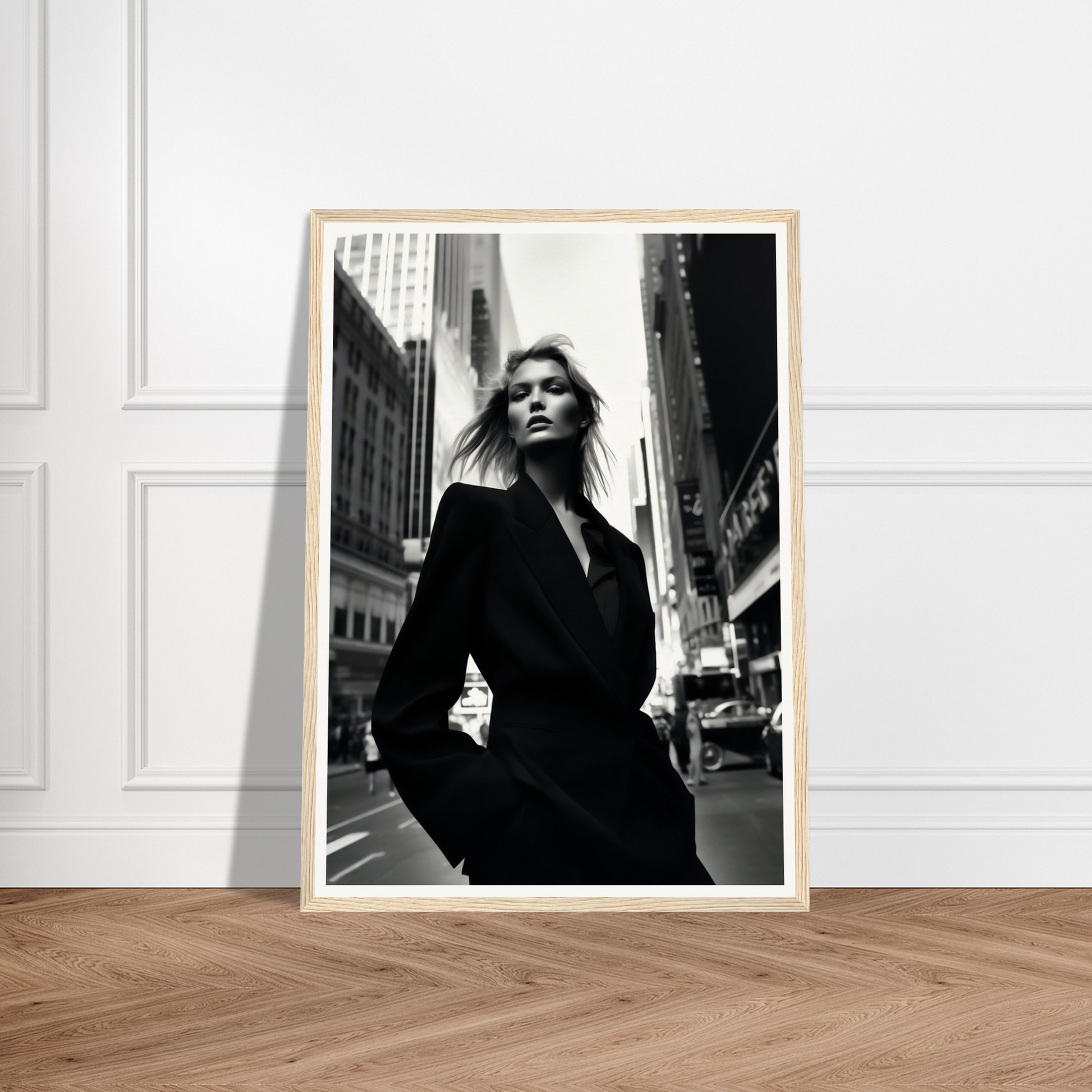 Framed black and white photograph of a woman in a dark coat standing on a city street.