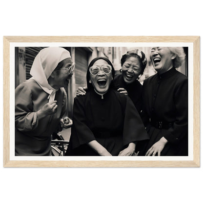 Black and white photograph of four women laughing joyously together.