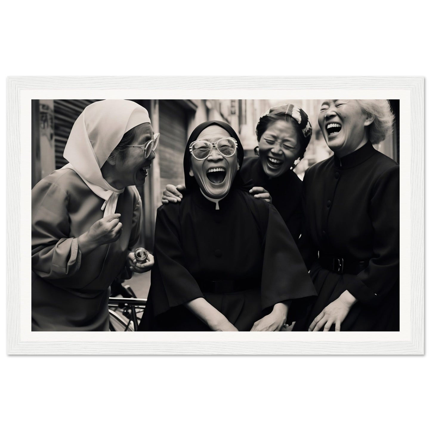 Black and white photograph of four women laughing joyfully together.