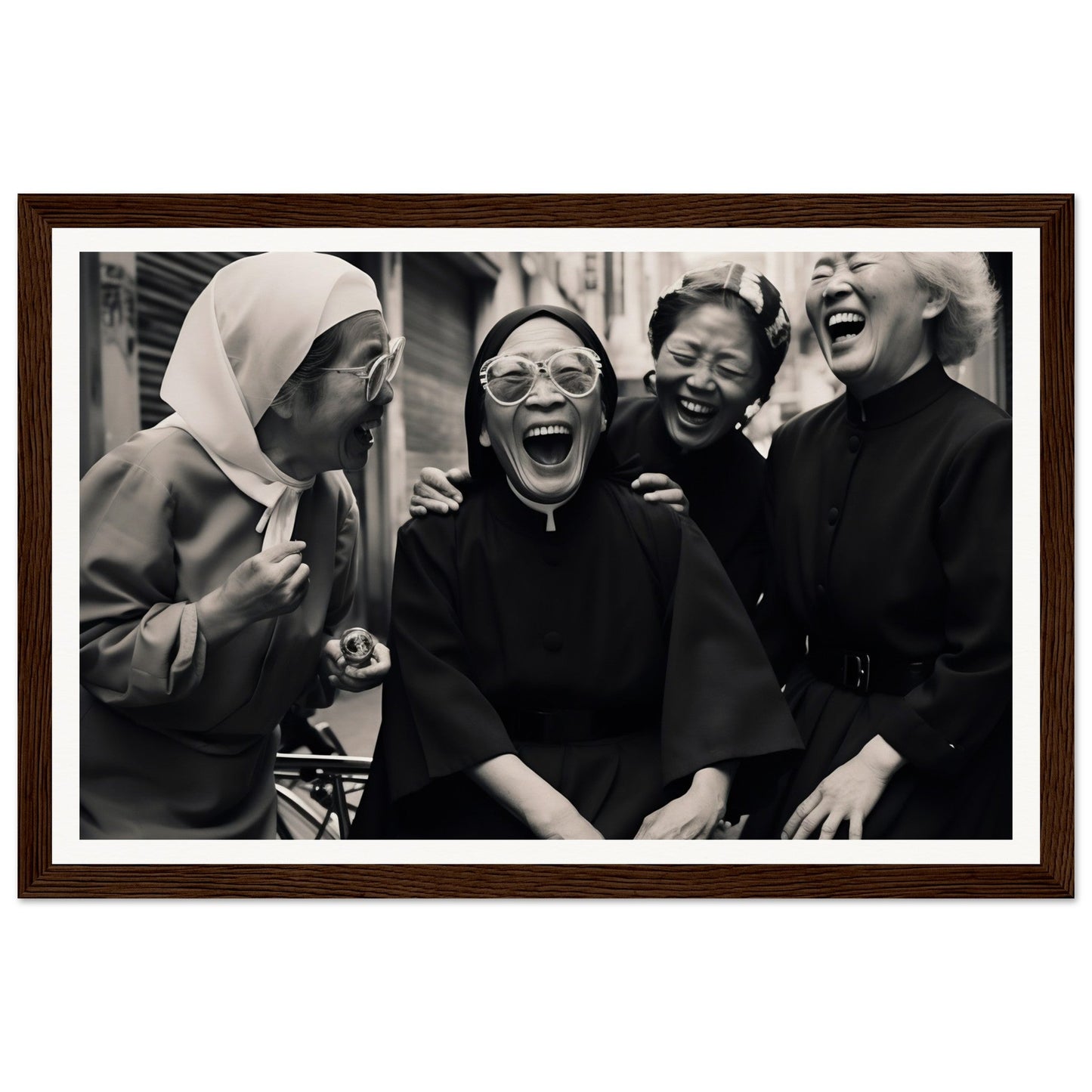 Black and white photograph of four women laughing joyfully together.