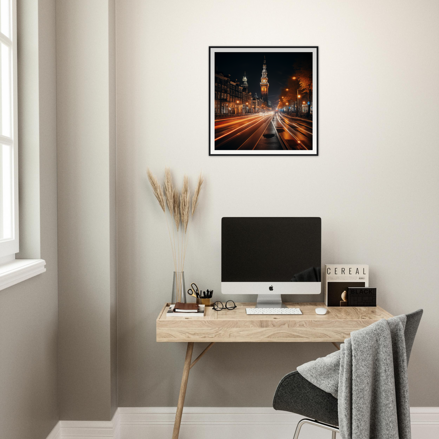 Minimalist wooden desk with iMac and Clockwork City Glow framed poster above