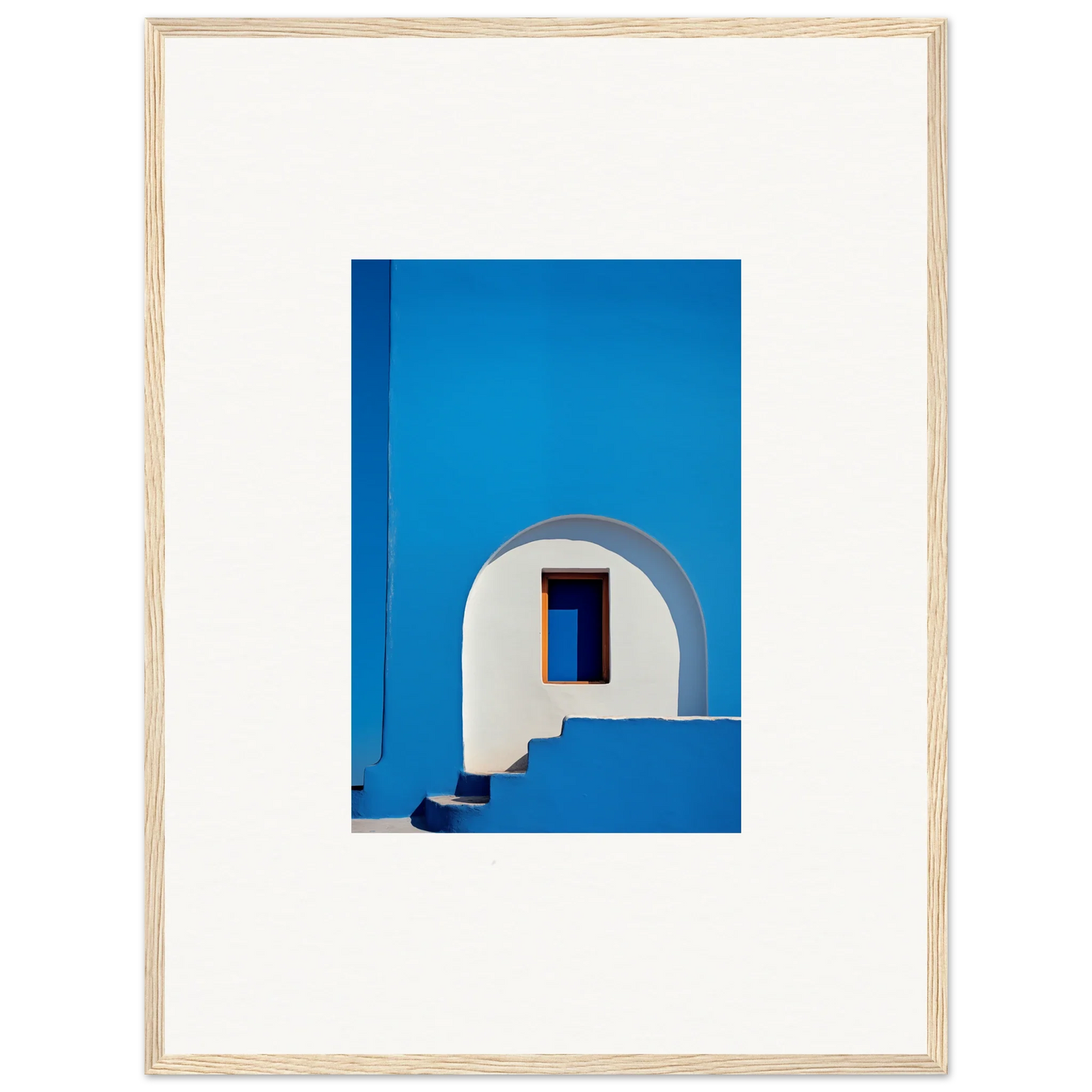 Vibrant blue wall with a white arched doorway in Dreams’ Premium Framed Wall Art