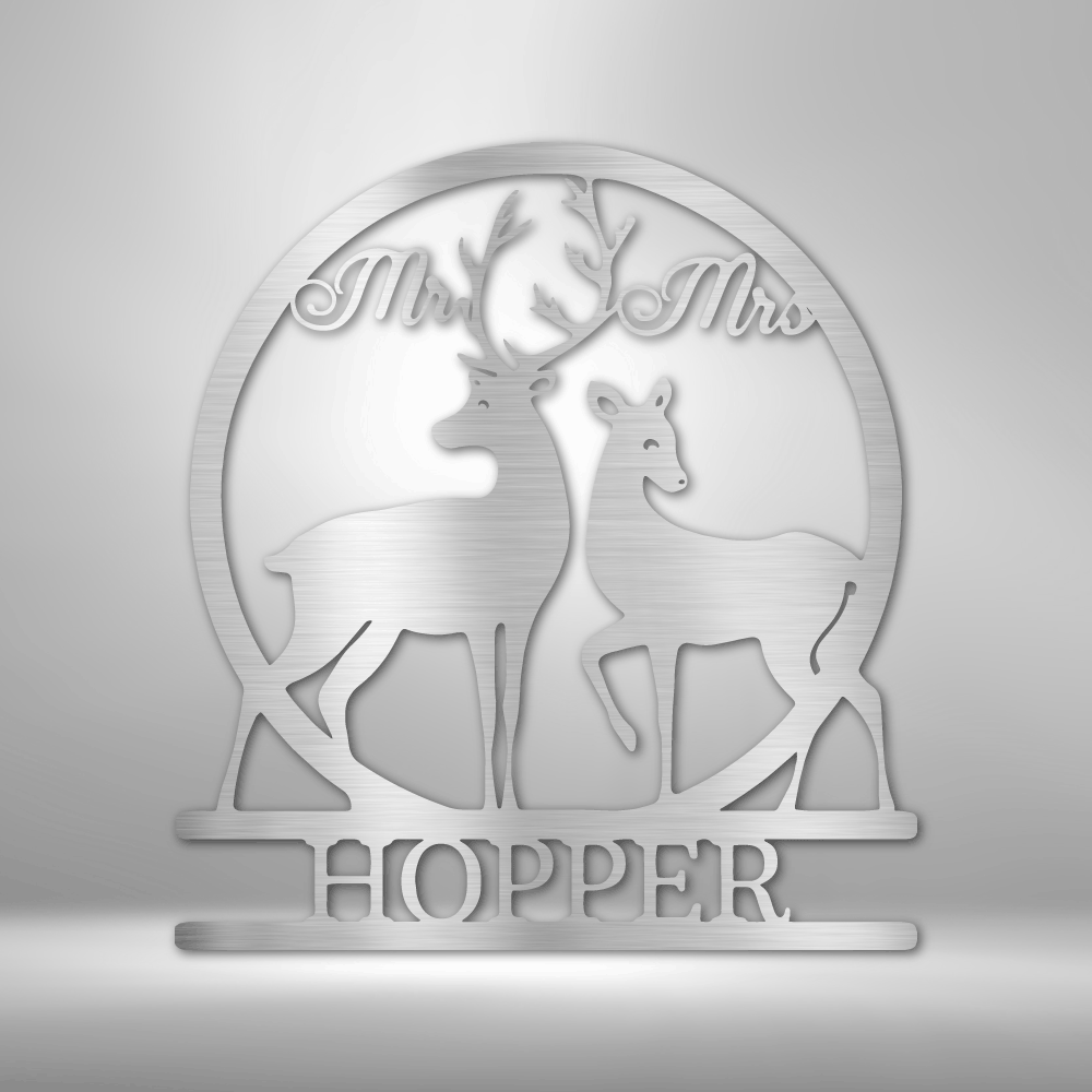Decorative metal or acrylic plaque featuring silhouettes of two deer and the text ’Mr & Mrs HOPPER’.