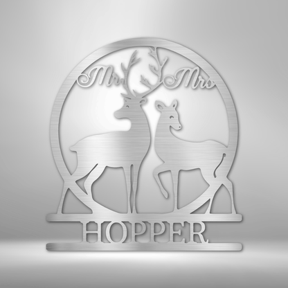 Decorative metal or acrylic plaque featuring silhouettes of two deer and the text ’Mr & Mrs HOPPER’.
