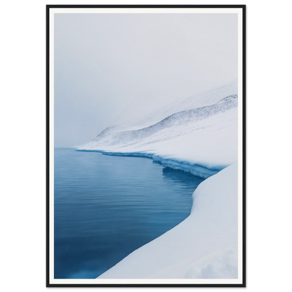 Framed wall art of a snowy landscape with calm blue water under an overcast sky.