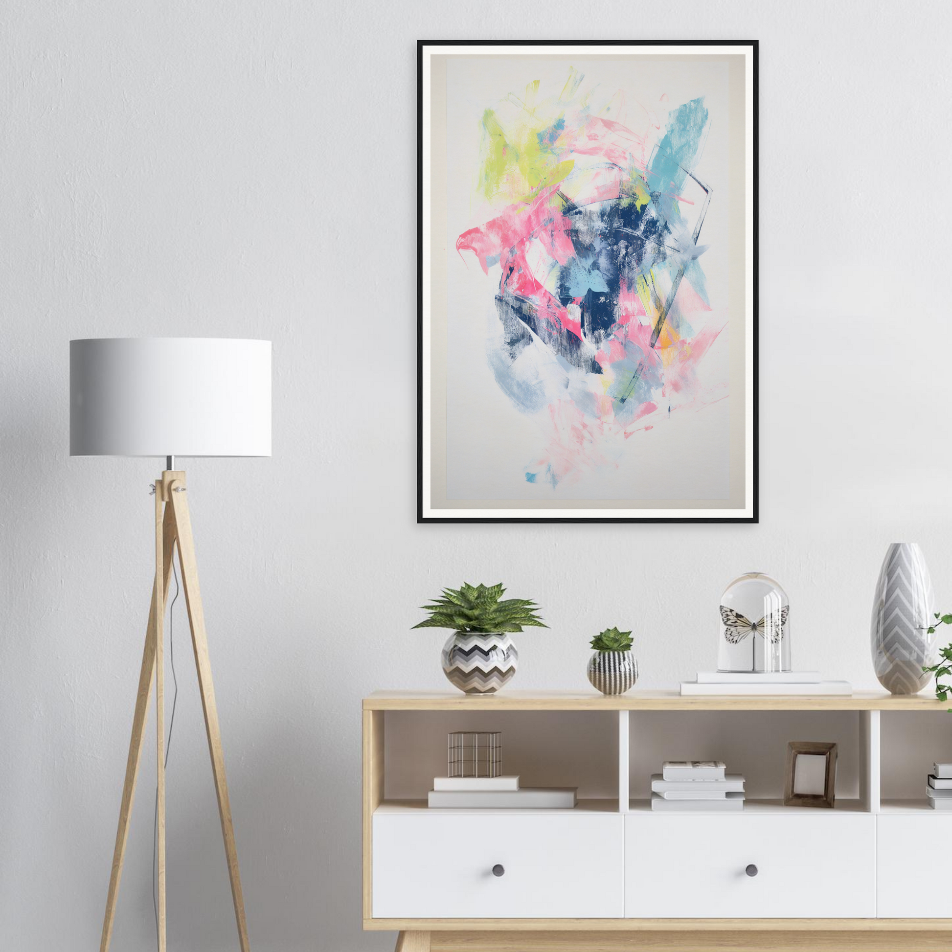 Framed wall art above the sideboard with plants, decor, and a white floor lamp adds chic interior design.