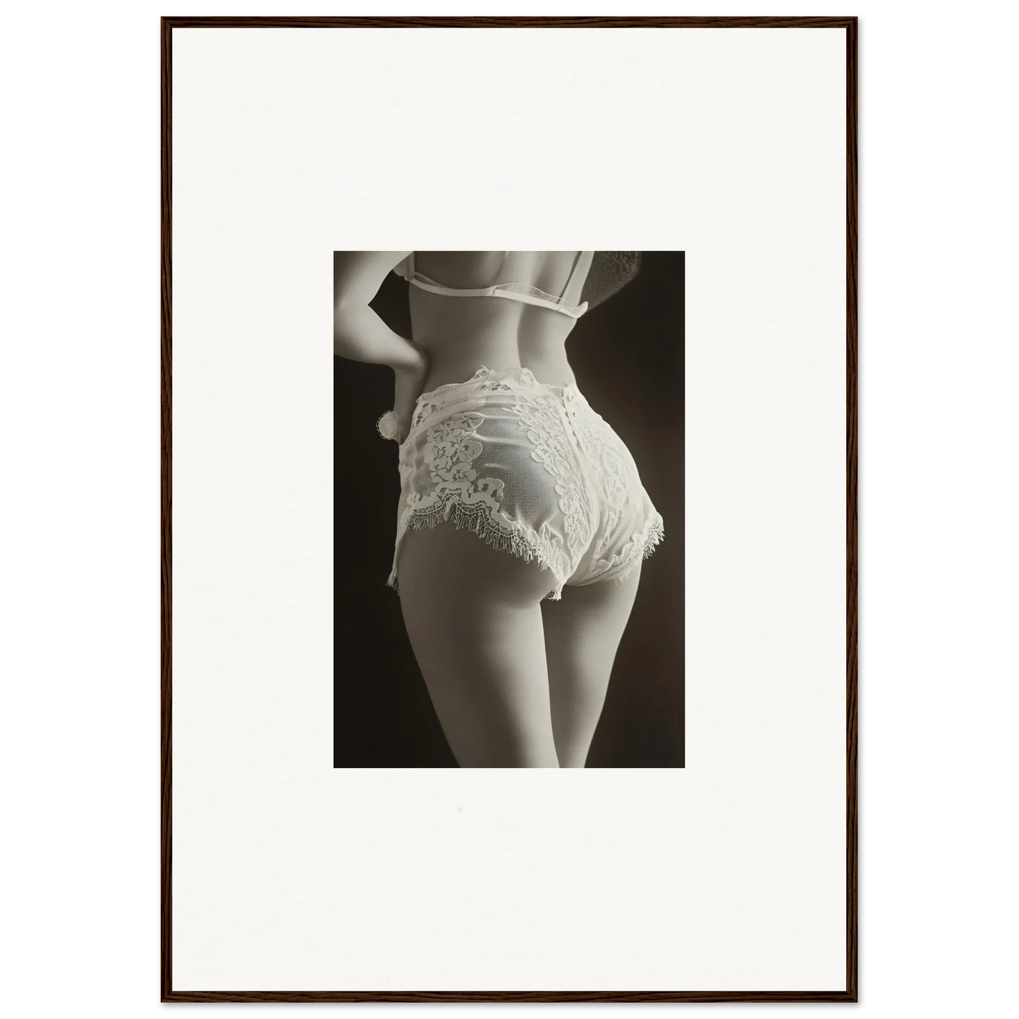 Framed black and white wall art of woman’s lower back and lace underwear for room decoration