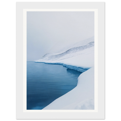 Framed wall art of a snowy landscape with a calm lake under a cloudy sky.