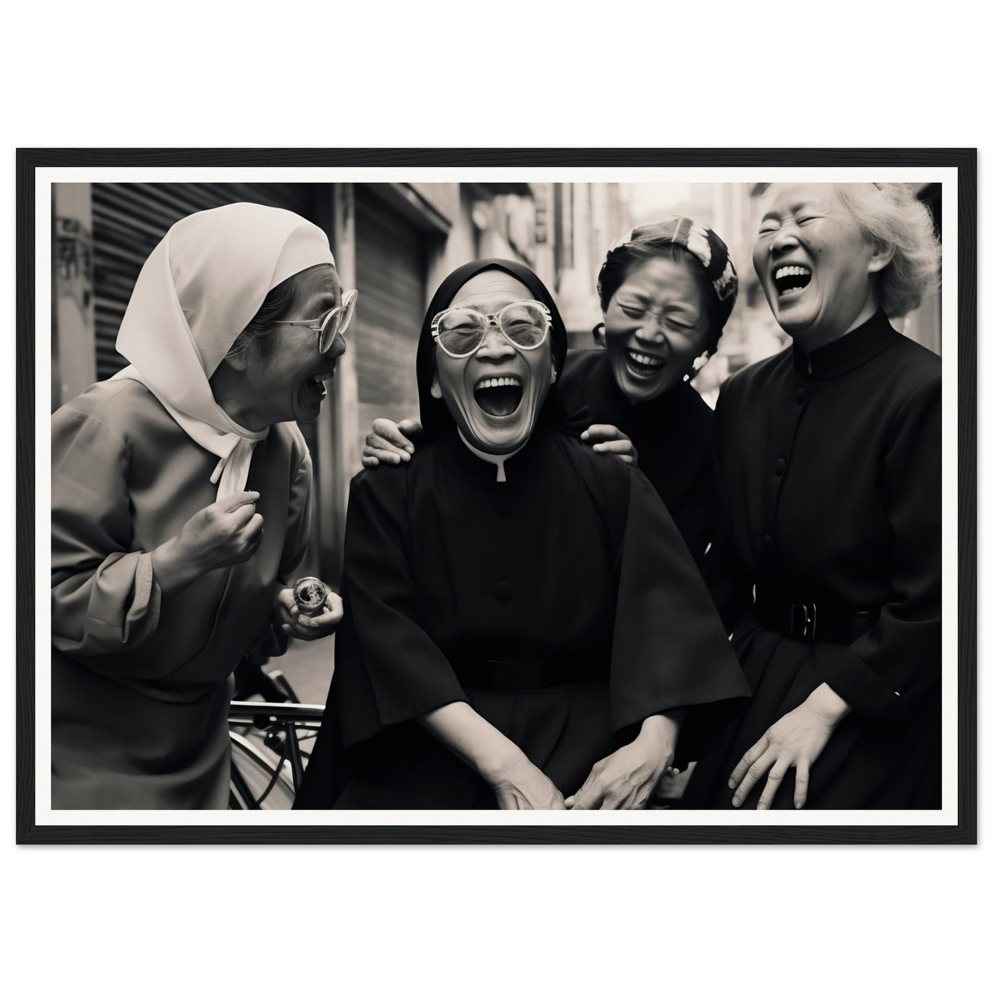 Black and white photograph of four women laughing joyfully together.