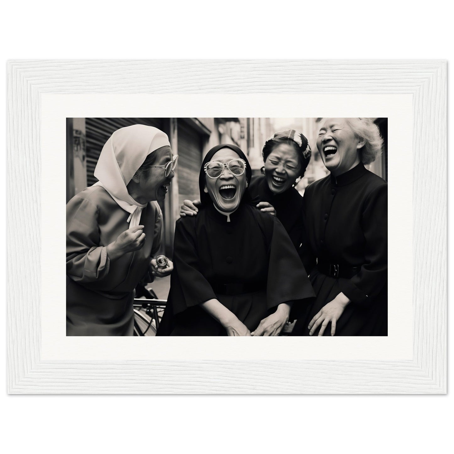 Black and white photograph of four women laughing together.