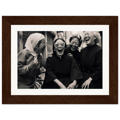 Black and white photograph of four women laughing together, framed in a wooden frame.