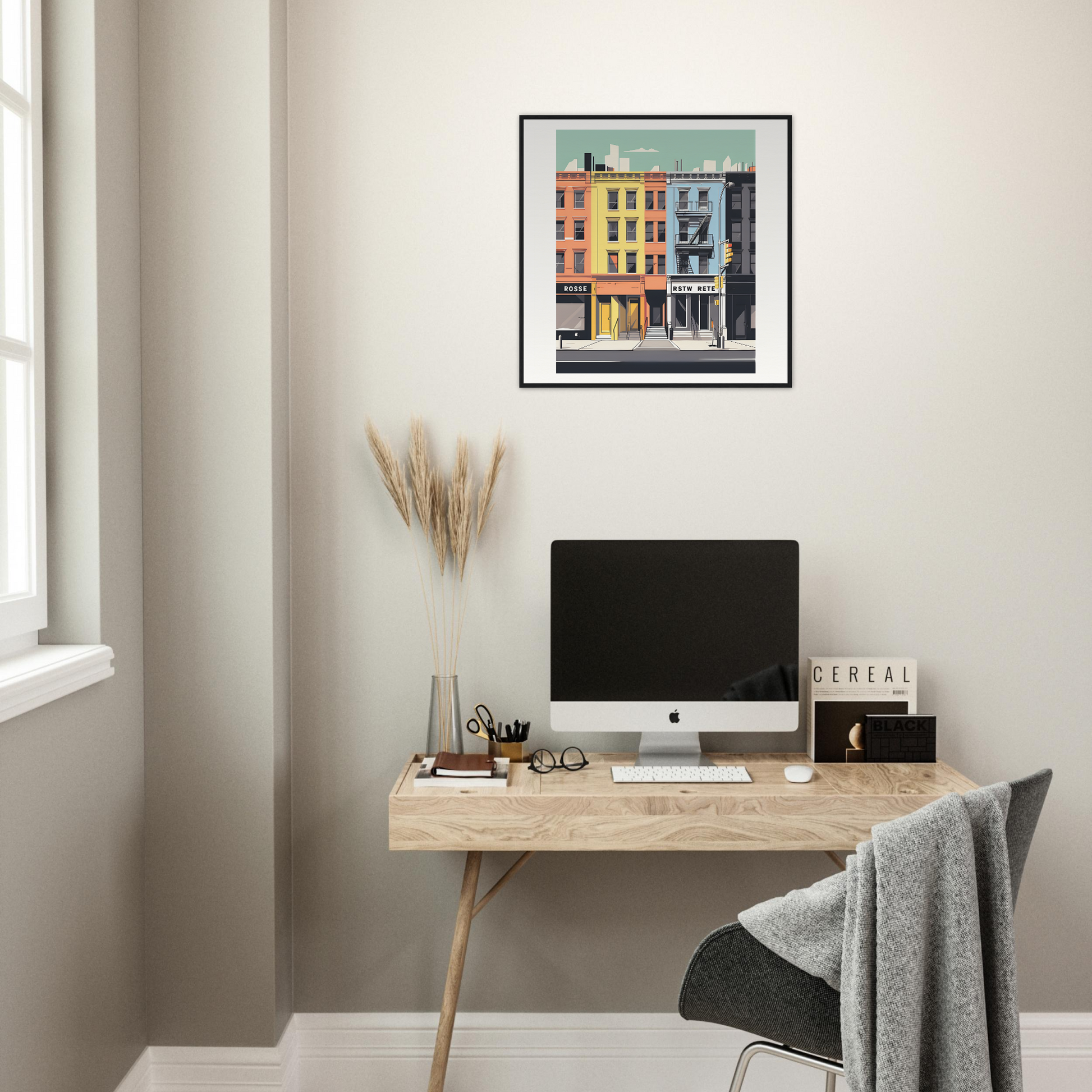 Minimalist wooden desk with iMac and colorful framed wall art from Sidewalk Dreams Aligning